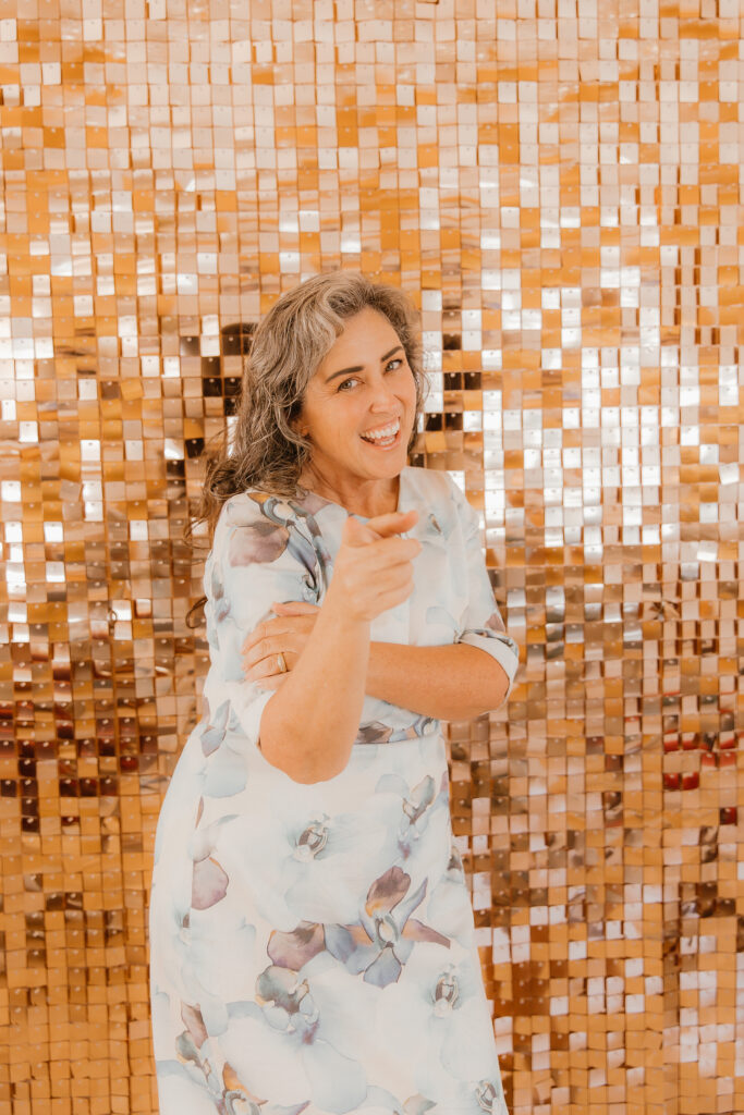Celebrant dances in front of the glimmer wall at the marriage office