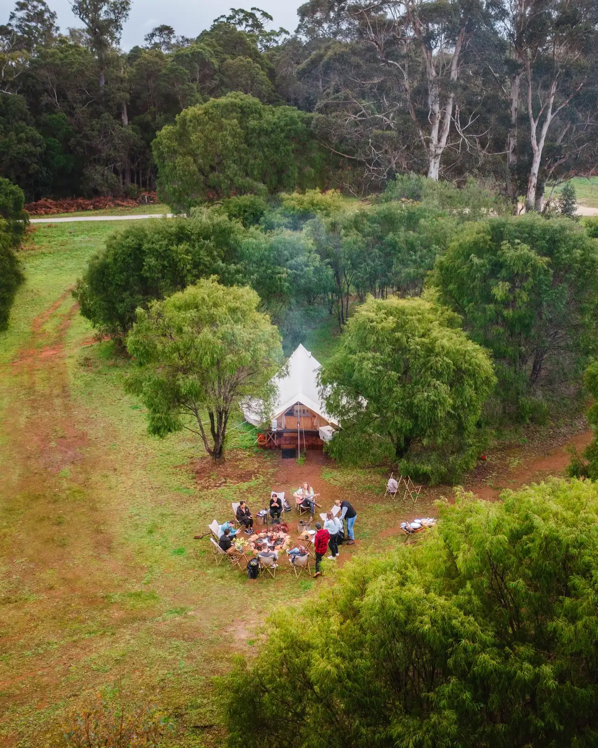 A small group gathered in a bush clearing among the trees near Margaret River